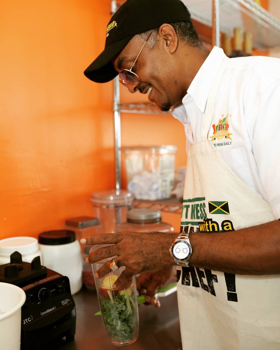 Juice Nation JA founder preparing a fresh blend in the kitchen